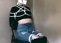 Woman wearing boots tied in chair