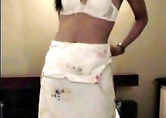 Alluring Asian TS strips white lingerie and swallows cock