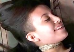 Submissive girl tied up to a bed and disciplined BDSM