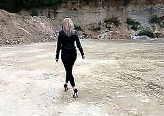 Grandma is walking around a gravel pit in constricted leggings and high heels!