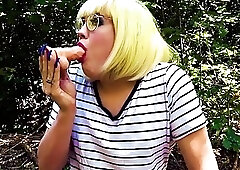 Slutty shemale Mandy May sucks a dildo and plays outdoor