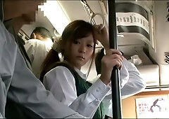 Young woman in plaid skirt submits to dominant partner during daring encounter on crowded bus