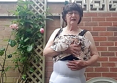 Mature babe Betty Spanxxx shows off her lingerie and girdle in the great outdoors