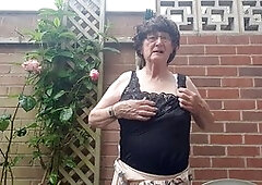 Mature babe Betty Spanxxx shows off her lingerie and girdle in the great outdoors