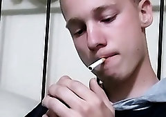 Cute blonde twink strokes his big cock solo while smoking