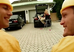 Two construction workers in yellow gear share a woman on a floral chaise during a steamy outdoor DP session