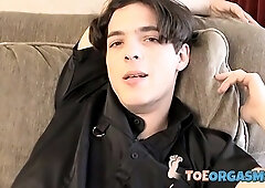 Skinny twink massages his feet and strokes massive dick