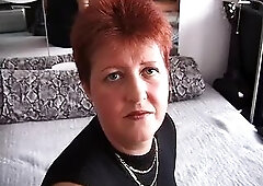 Redhead playing with her fingers and his rod laying on their daybed and feeling fleshly.